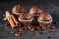 Chocolate cupcake with icing and chocolate bar in Dark lighting,Homemade delicious chocolate muffin on wooden background close-up