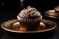 Chocolate cupcake with nuts on a golden plate
