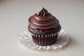 Chocolate Cupcake With Swirled Frosting on a White Table