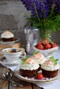 Chocolate cupcake with vanilla cream and strawberries. Vintage style Royalty Free Stock Photo