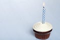 Chocolate cupcake with vanilla frosting and candle Royalty Free Stock Photo