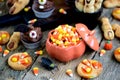 Chocolate cupcakes `bats` and shortbread cookies `witch`s fingers` - delicious bakery sweets for the celebration of Halloween. Royalty Free Stock Photo