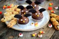 Chocolate cupcakes `bats` and shortbread cookies `witch`s fingers` - delicious bakery sweets for the celebration of Halloween. Royalty Free Stock Photo