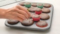 Chocolate cupcakes close up on baking pan. Chef checking cupcakes for doneness by using the toothpick test Royalty Free Stock Photo