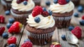 Chocolate cupcakes with cream cheese frosting and fresh berries Royalty Free Stock Photo