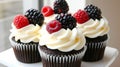 Chocolate cupcakes with cream cheese frosting and fresh berries Royalty Free Stock Photo