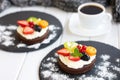 Chocolate cupcakes with cream cheese, fruits and berries. Mini cakes with custard cream. Coffee dessert Royalty Free Stock Photo