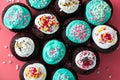 Chocolate cupcakes decorated with colorful icing sugar and sprinkles at home. Festive sweet food close-up Royalty Free Stock Photo