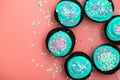 Chocolate cupcakes decorated with turquoise and pink icing sugar and sprinkles at home. Festive sweet food close-up Royalty Free Stock Photo