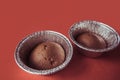 Chocolate cupcakes in foil baking dish on Marsala background. Brown muffins in foiled baking forms