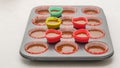 Cupcake pan lined with paper liners, and silicon molds filled with chocolate cake batter