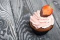 Chocolate cupcakes with strawberry cream. Decorated with half strawberries in chocolate