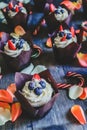 Chocolate cupcakes with white cream and berries on the top Royalty Free Stock Photo