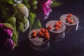 Chocolate on a dark mirror background with peonies in warm colors Royalty Free Stock Photo