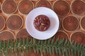 Chocolate dessert with filling of caramel, nuts and nougats. The cake is covered with chocolate on a wooded background Royalty Free Stock Photo