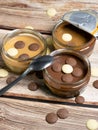 Chocolate desserts with chocolate buttons on a wooden background. Royalty Free Stock Photo