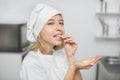 Chocolate desserts, chocolate drops, sweets. Close up portrait of young female confectioner, enjoying her work in pastry