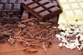 Chocolate in diffrent color. milk, dark and white chocolate bars on table Royalty Free Stock Photo