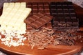 Chocolate in diffrent color. milk, dark and white chocolate bars on table Royalty Free Stock Photo