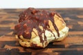 Chocolate Dipped Cream Puff On A Cutting Board With a White Background Royalty Free Stock Photo