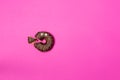 Chocolate donut cut in triangle with eyes, top view. Royalty Free Stock Photo