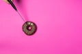 Chocolate donut with eyes, female hand slicing donut knife, top view2 Royalty Free Stock Photo