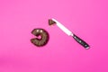 Chocolate donut with eyes and knife, top view. Royalty Free Stock Photo