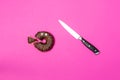 Chocolate donut with eyes and knife, top view. Royalty Free Stock Photo