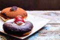 Chocolate donut with strawberry with blue painted wooden table background Royalty Free Stock Photo