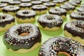 Chocolate donuts on lime green background, close-up, 3d rendered pattern. Food background, doughnuts illustration with shallow