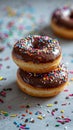 Chocolate Donuts On a white table with colorful paper scattered all over the picture Royalty Free Stock Photo