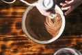 Chocolate dough with a whisk. Hand mixing the ingredients of a pie in a bowl with a blender Royalty Free Stock Photo