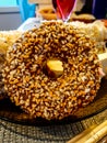 chocolate doughnut sprinkled with nut slices close up