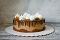 chocolate drip cake with salted caramel and snow white merengues Royalty Free Stock Photo