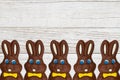 Chocolate Easter Bunnies On Grained Wood Background