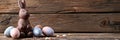 Chocolate Easter bunny and Easter Painted Eggs on wooden background Royalty Free Stock Photo