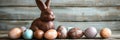 Chocolate Easter bunny and Easter Painted Eggs on wooden background Royalty Free Stock Photo