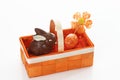 Chocolate easter bunny and egg in orange basket Royalty Free Stock Photo