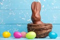 Chocolate Easter bunny, eggs and sweets on rustic background Royalty Free Stock Photo