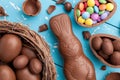 Chocolate Easter bunny, eggs and sweets on rustic background Royalty Free Stock Photo