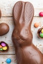 Chocolate Easter bunny, eggs and sweets on rustic background Royalty Free Stock Photo
