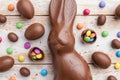 Chocolate Easter bunny, eggs and sweets on rustic background Royalty Free Stock Photo