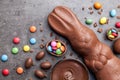 Chocolate Easter bunny, eggs and sweets on rustic background Royalty Free Stock Photo