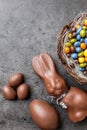 Chocolate Easter bunny, eggs and sweets on rustic background Royalty Free Stock Photo