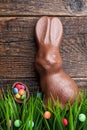 Chocolate Easter bunny and eggs on wooden background Royalty Free Stock Photo