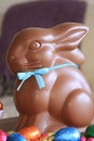 Chocolate Easter bunny sits among chocolate eggs