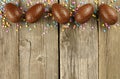 Chocolate Easter egg border on wood Royalty Free Stock Photo