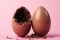 Chocolate Easter egg broken in half on pastel pink background with creative copy space. Minimal Easter holiday concept Royalty Free Stock Photo