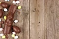 Chocolate Easter egg and bunny side border against rustic wood Royalty Free Stock Photo