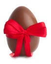 Chocolate Easter egg with color ribbon on white background Royalty Free Stock Photo